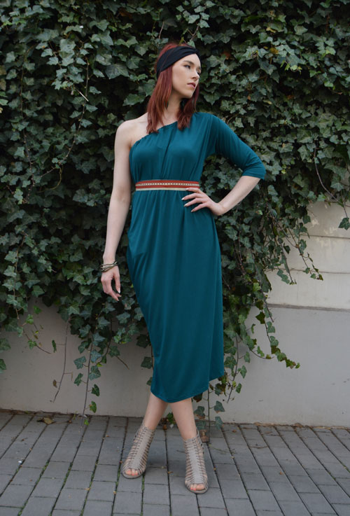 Model is wearing reversible emerald midi dress with one sleeve