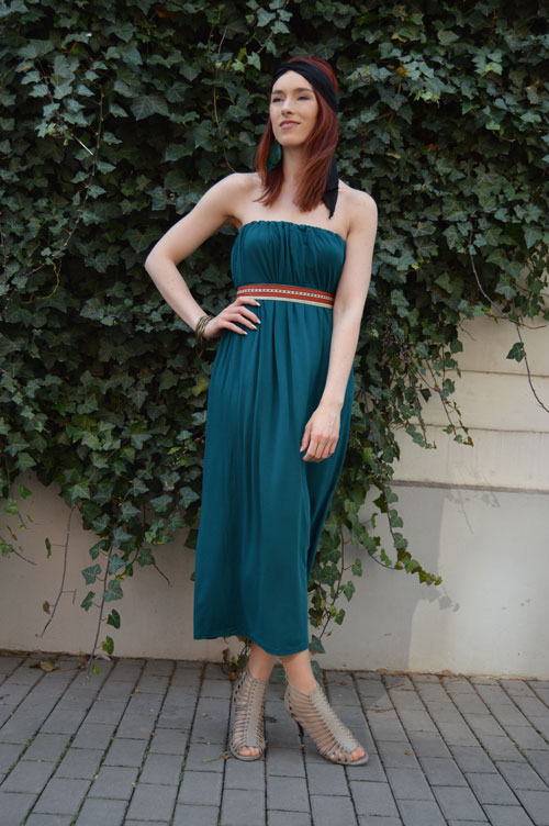 Model is wearing emerald midi strapless dress