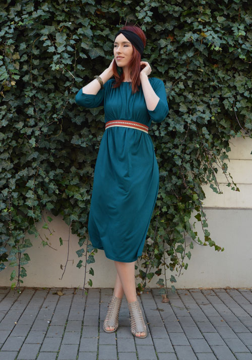 Model is wearing reversible emerald midi dress with two sleeves